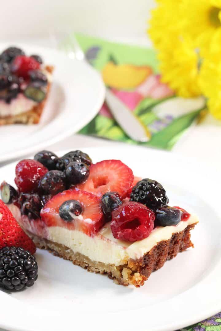 Close-up shot of a slice of boysenberry cream cheese tart