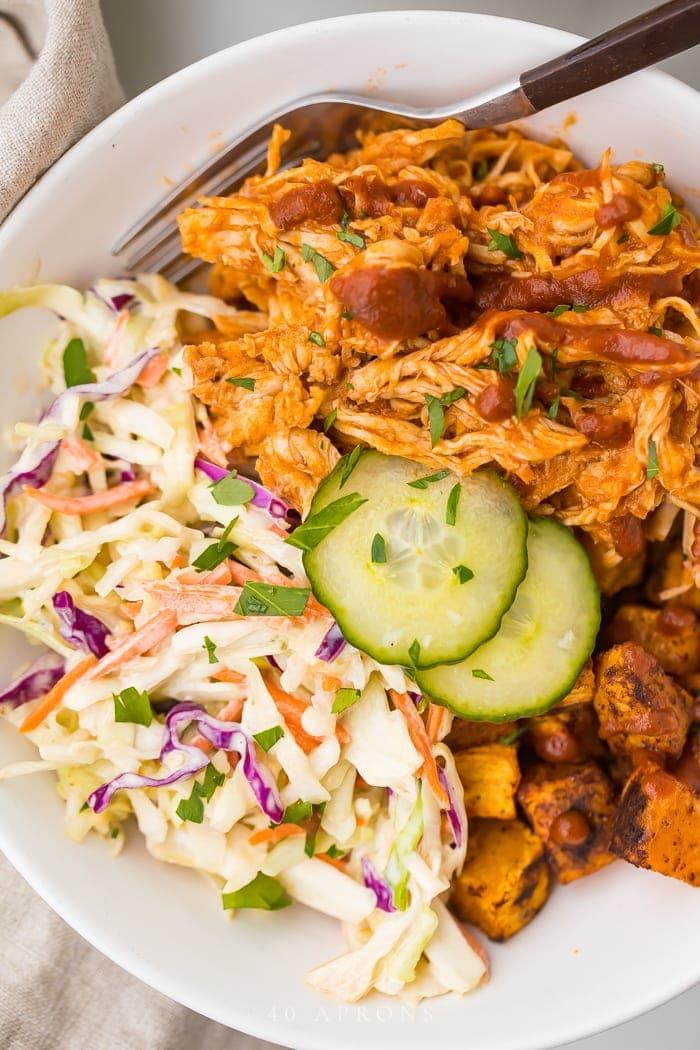 Close-up shot of a BBQ Chicken and Coleslaw Bowl, showing the texture and color of the ingredients.