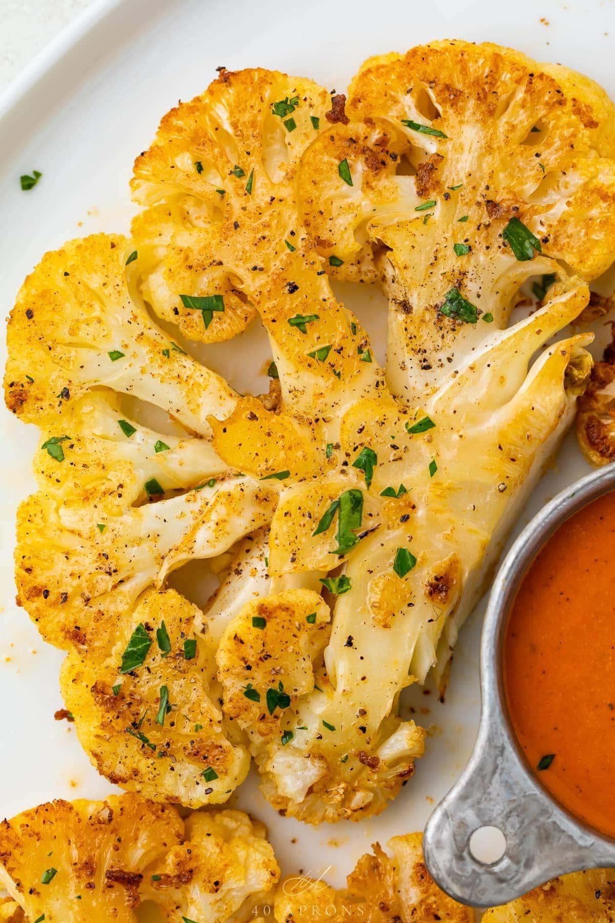 Close-up shot of smoked paprika BBQ cauliflower on a baking sheet