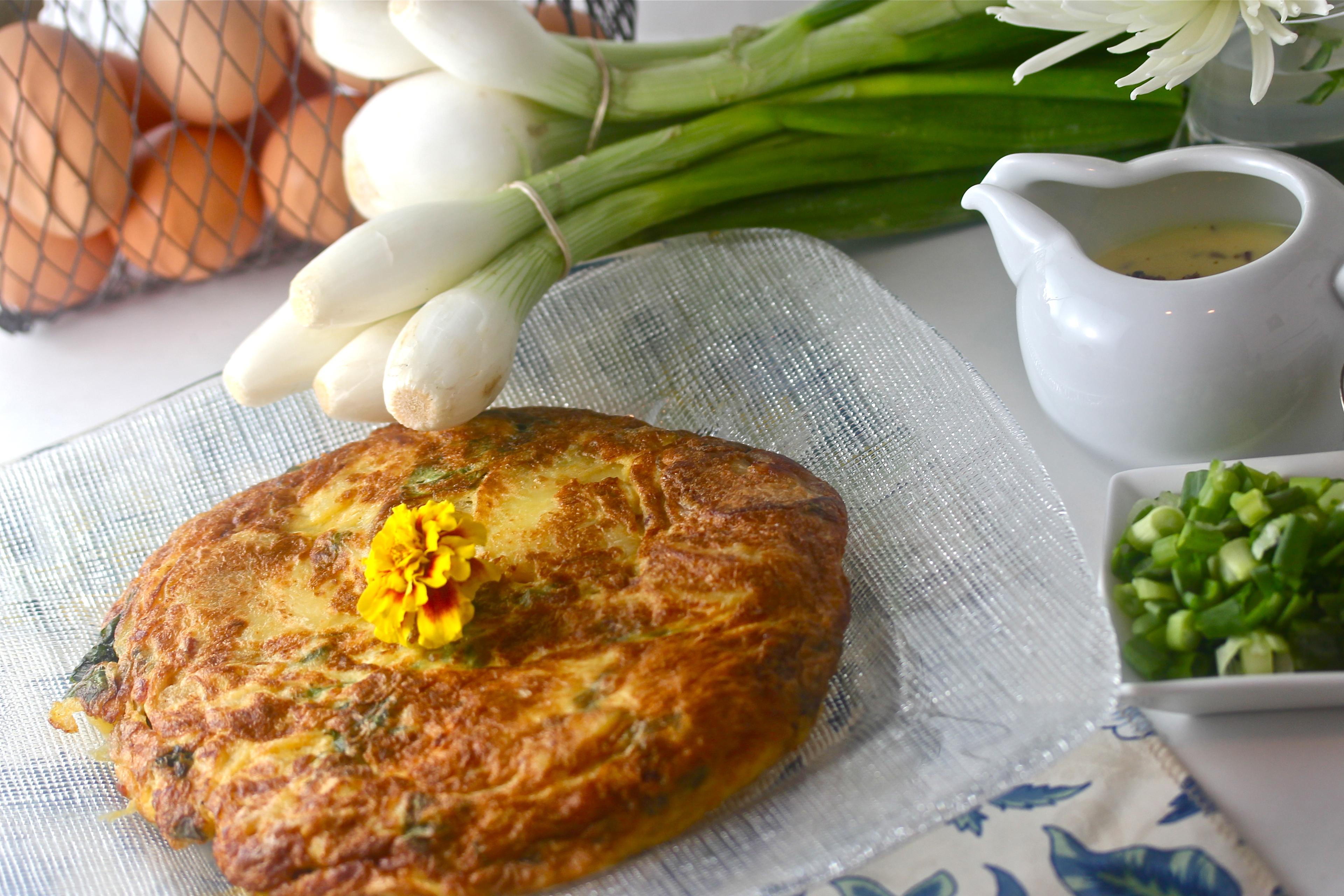 lavender and honey frittata being sliced in a skillet