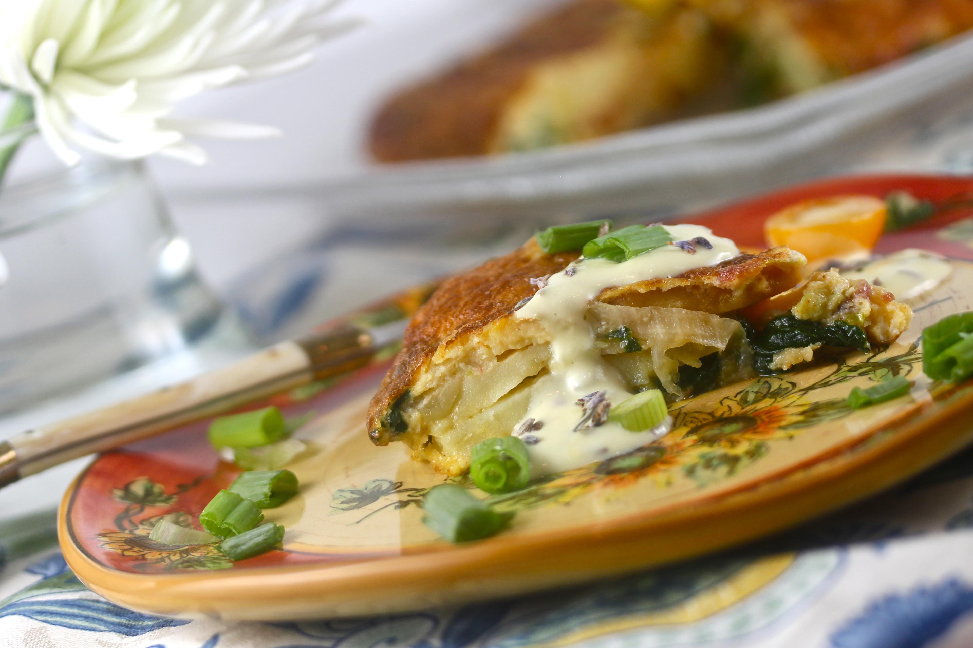 close up of a slice of lavender and honey frittata on a plate