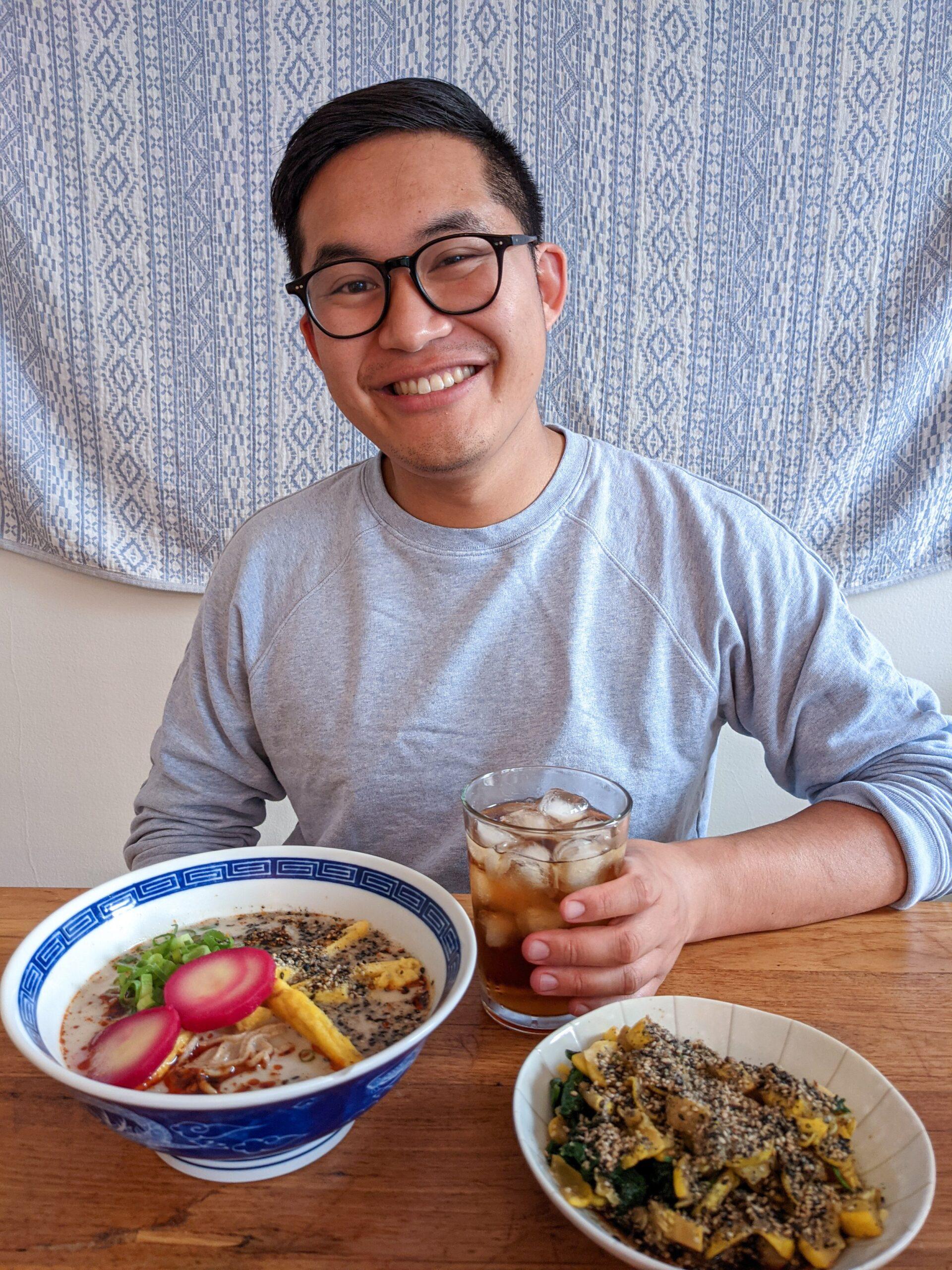 Person enjoying a bowl of vegetarian ramen