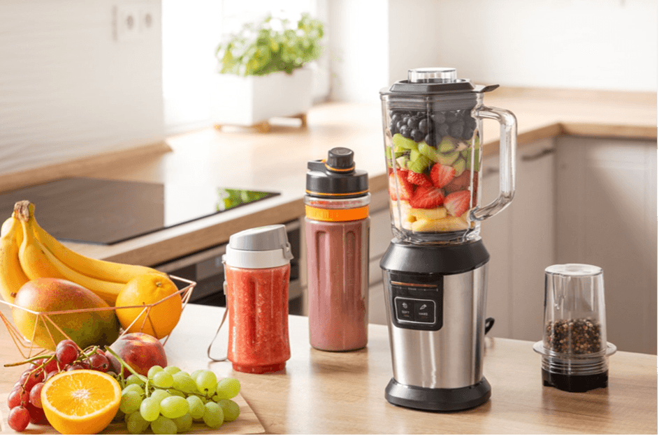 Variety of fruits and vegetables near a blender