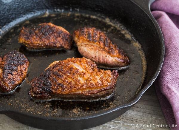 Duck breast searing in a cast iron skillet