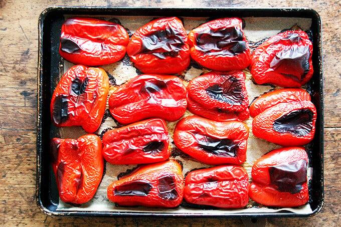 A close-up shot of a red bell pepper being roasted in the oven
