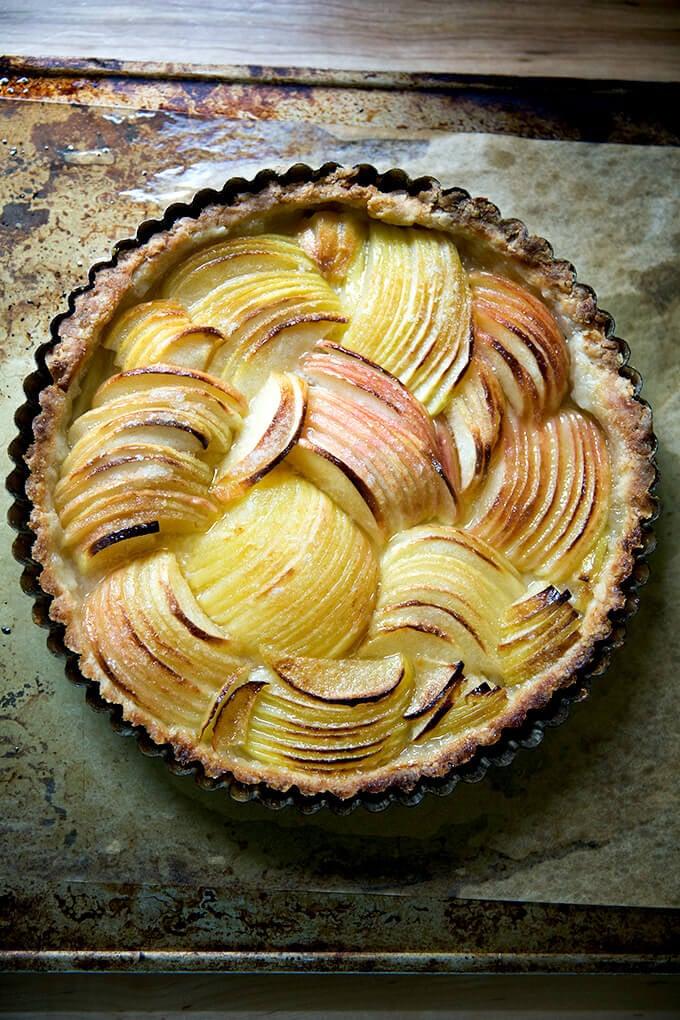 Close-up shot of a slice of apple and gruyere tart