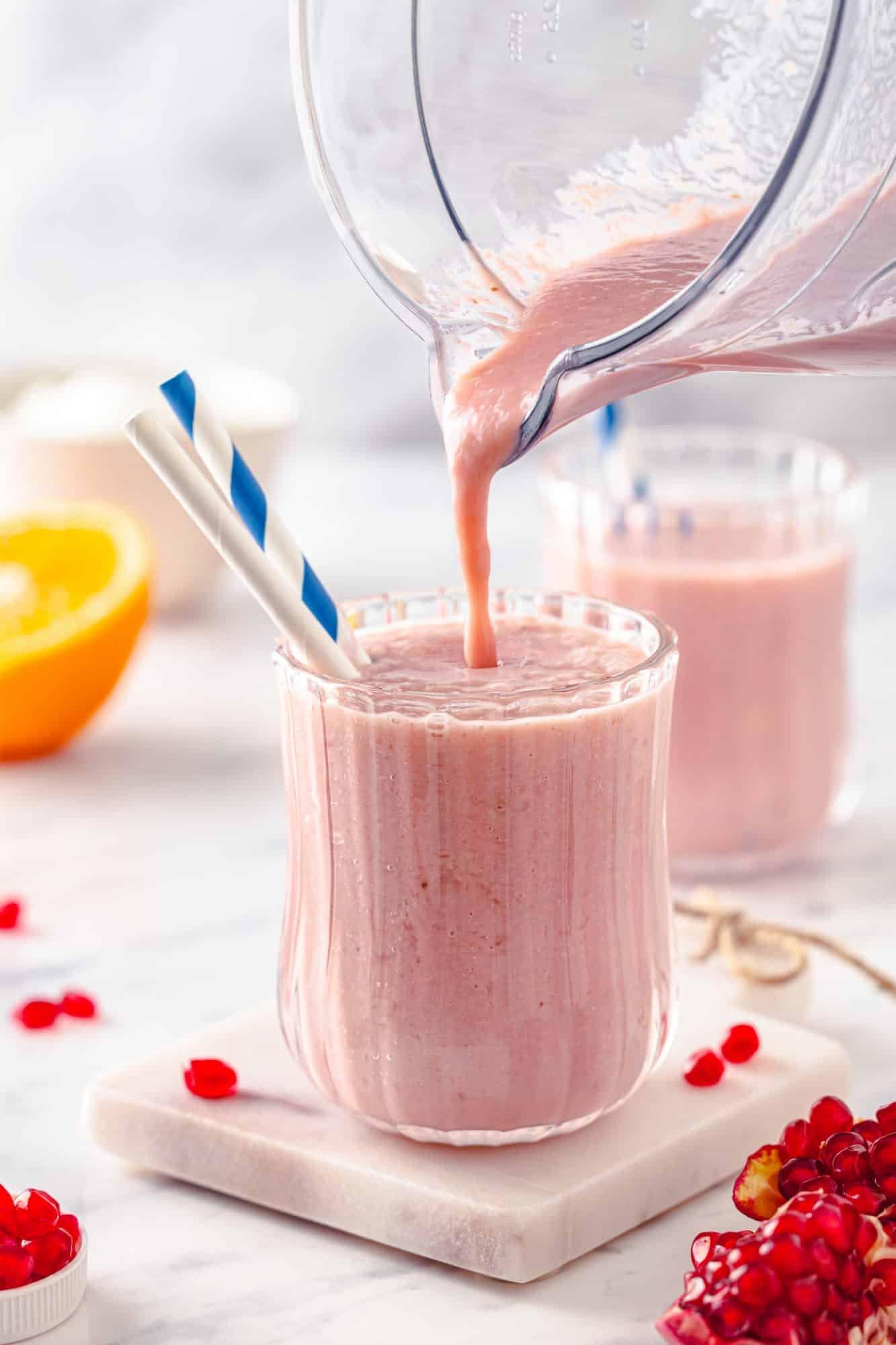 pomegranate ginger smoothie being poured into a glass