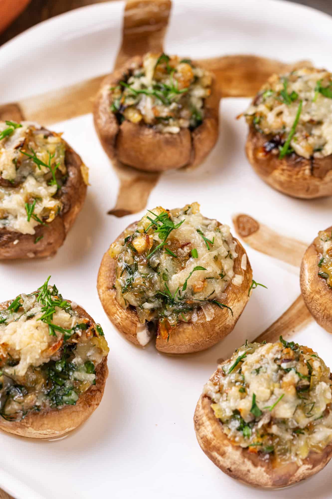 appetizing plate of golden brown stuffed mushrooms with fresh herbs