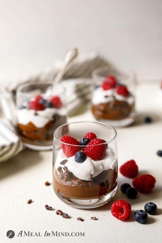 Close-up shot of a decadent avocado chocolate mousse with toasted coconut flakes