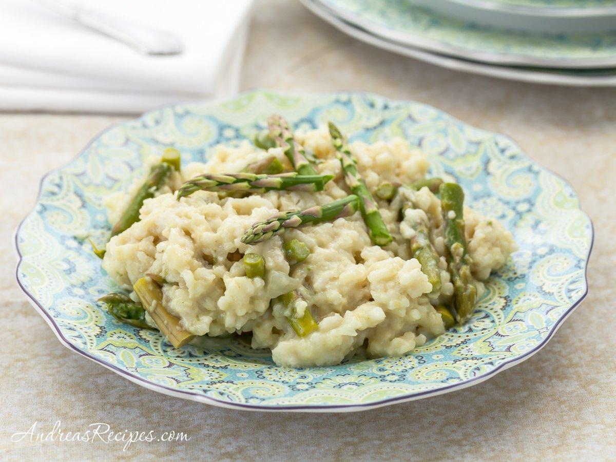 overhead shot of the finished spicy asparagus risotto, garnished with chili flakes and parmesan