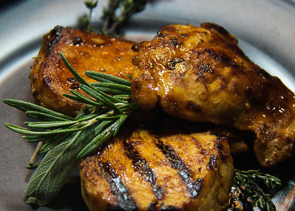 Grilled chicken marinated in guava jerk marinade, garnished with fresh herbs