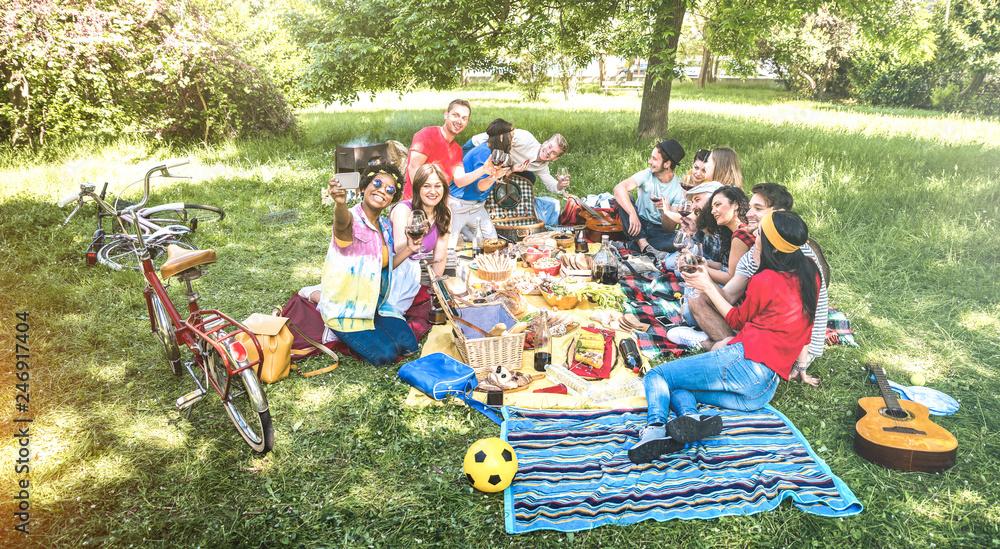 A group of people enjoying grilled corn and avocado spring rolls outdoors at a picnic.