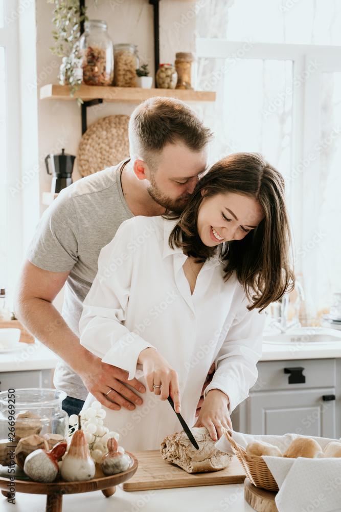 A couple cooking together in a kitchen