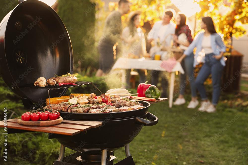A group of friends grilling and enjoying food together