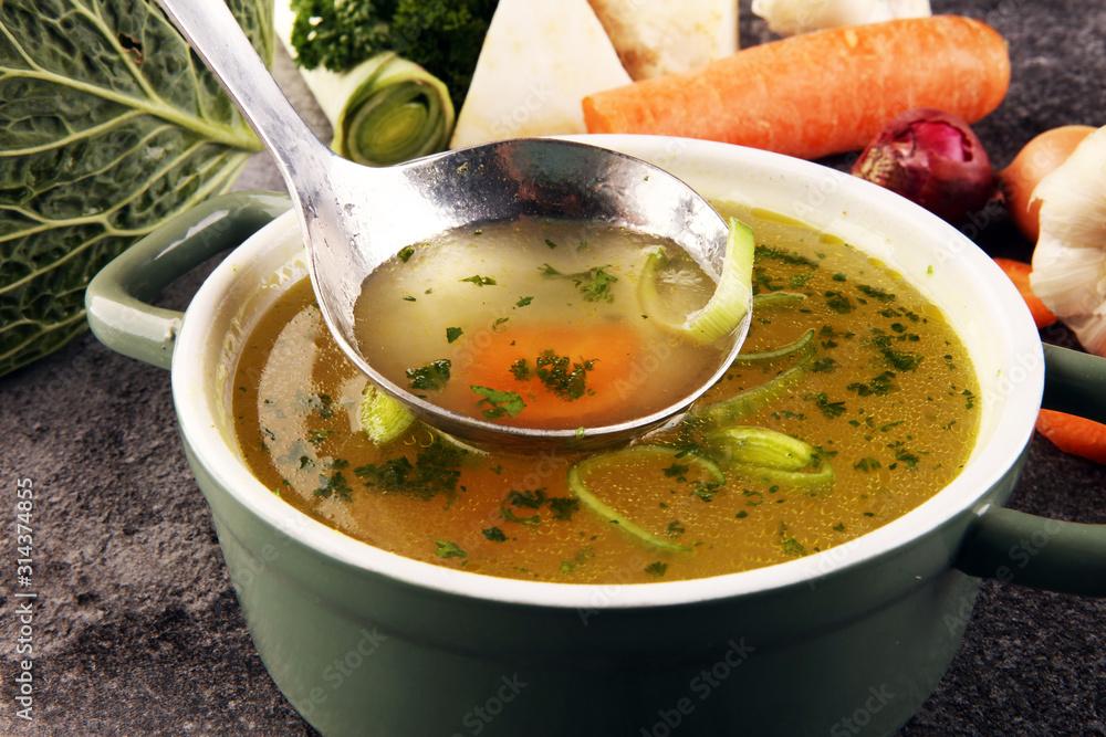 Close-up shot of a colorful vegetable broth with various vegetables visible