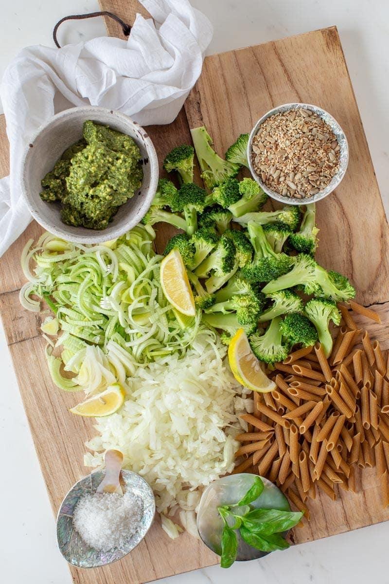 close-up of orange peel pesto ingredients laid out on a wooden table