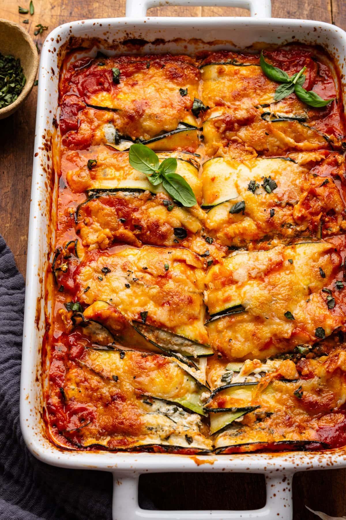 A delicious and appetizing zucchini lasagna, with layers of zucchini, ricotta cheese, and marinara sauce visible.