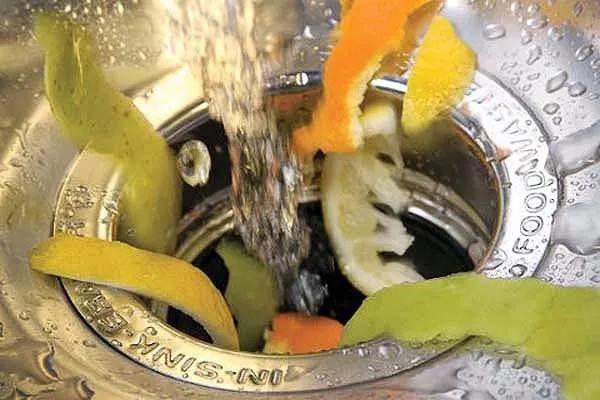 close up of soggy fruit skewer being tossed into the trash
