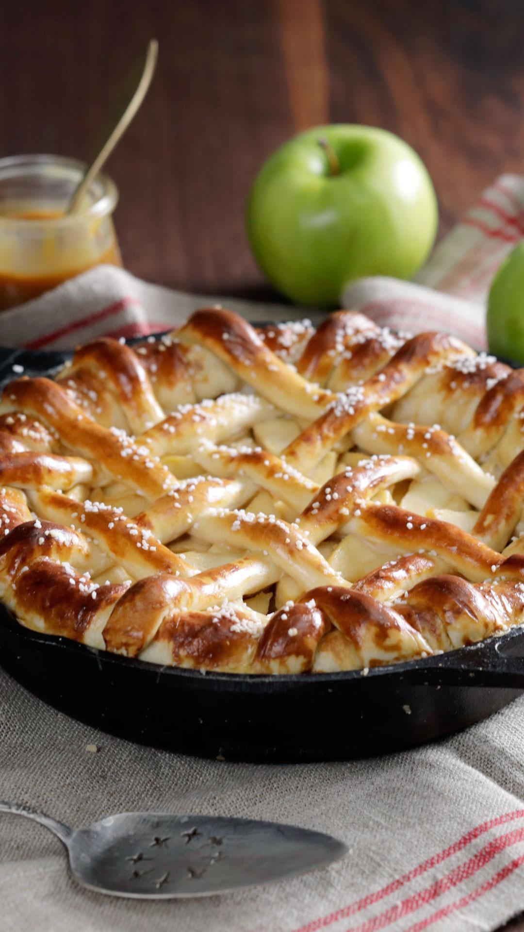 Close up of the finished apple pie with a pretzel crust, showing the texture of the crust and the apples inside