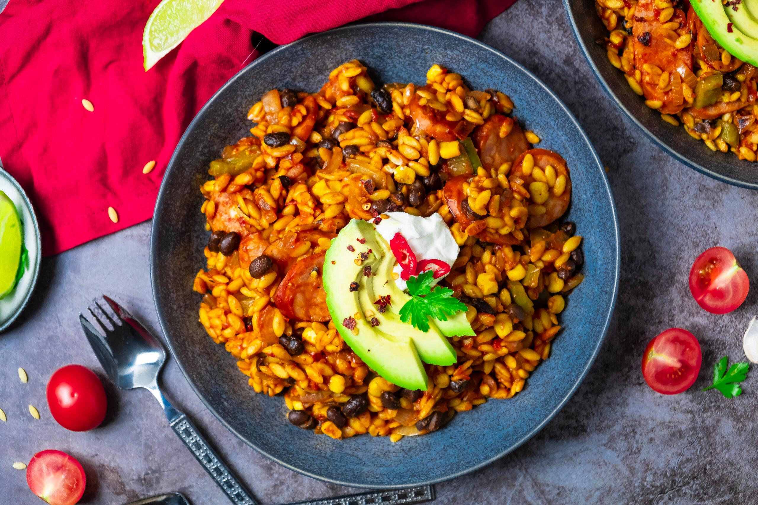 Close-up shot of a bowl of spicy chorizo and black bean gluten-free pasta, highlighting the texture and vibrant colors.