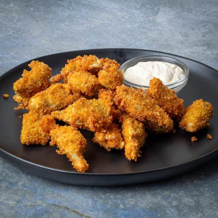 Close-up shot of golden-brown, crispy tempura-fried artichoke hearts