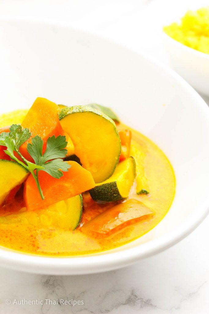 Vegan Thai Panang Curry with Cashews in a bowl garnished with fresh cilantro and lime wedges