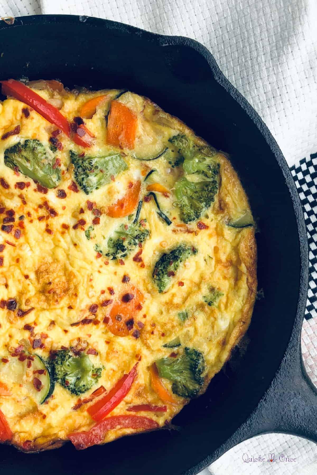Close-up shot of a slice of barley and vegetable frittata on a plate