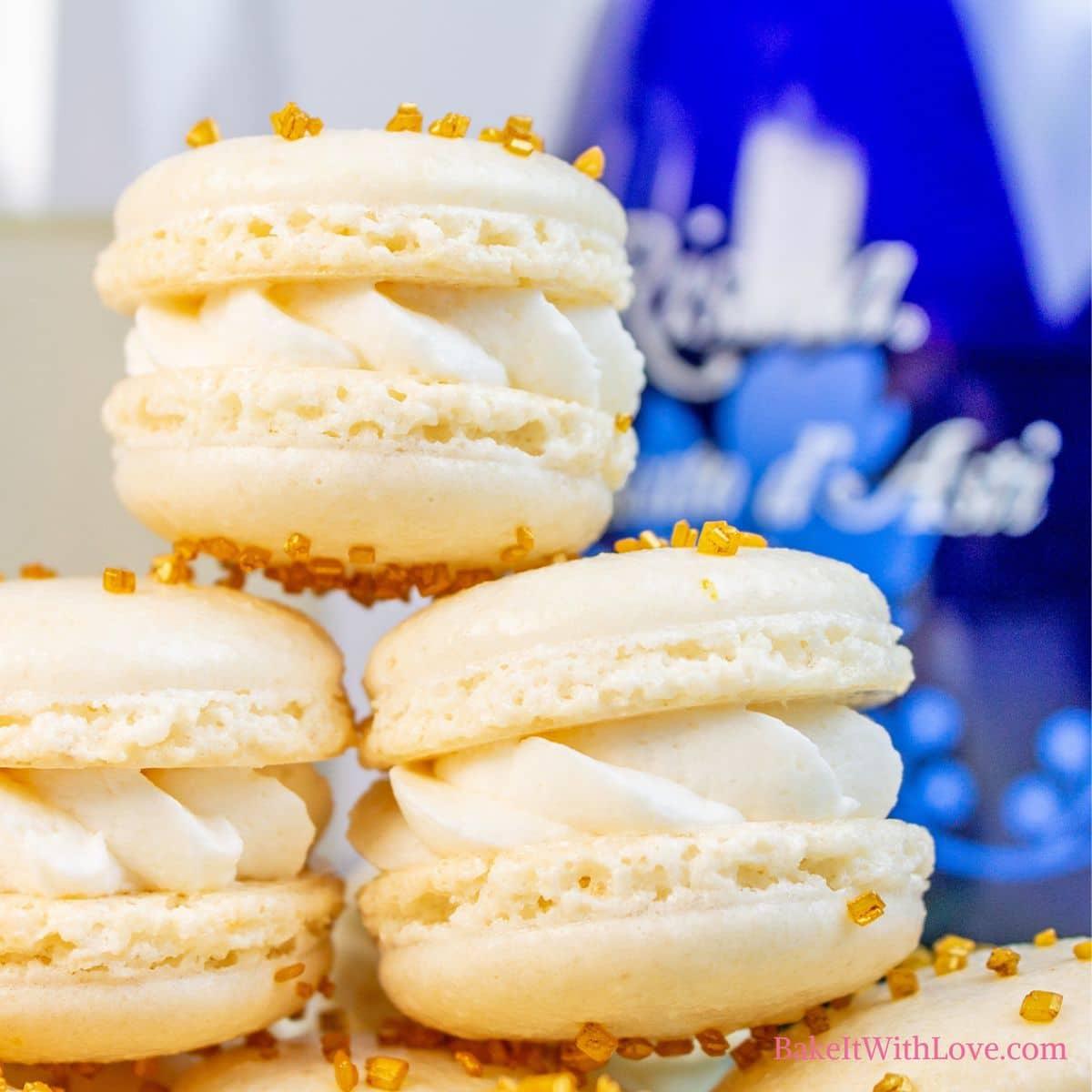 A beautifully decorated table setting with a plate of toasted almond and champagne macarons