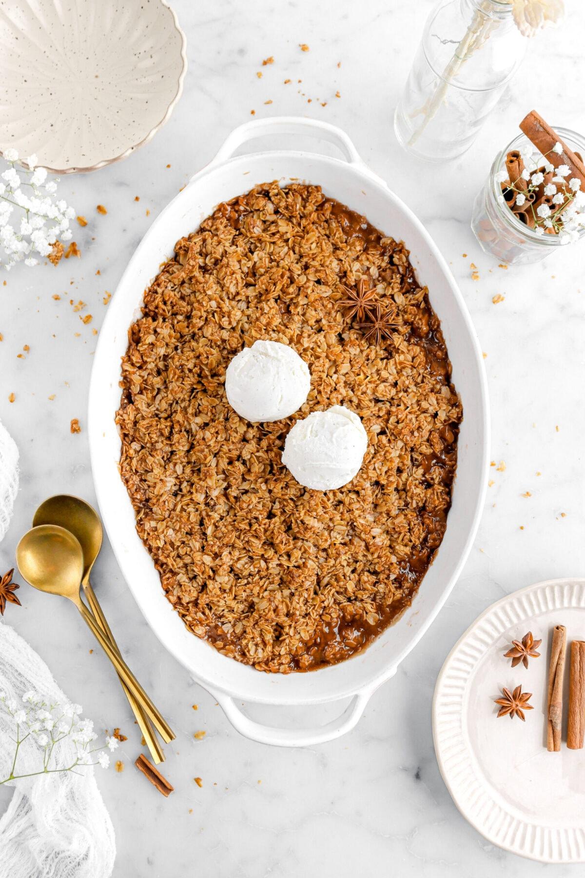 close-up shot of the apple crisp topping being sprinkled over the apples