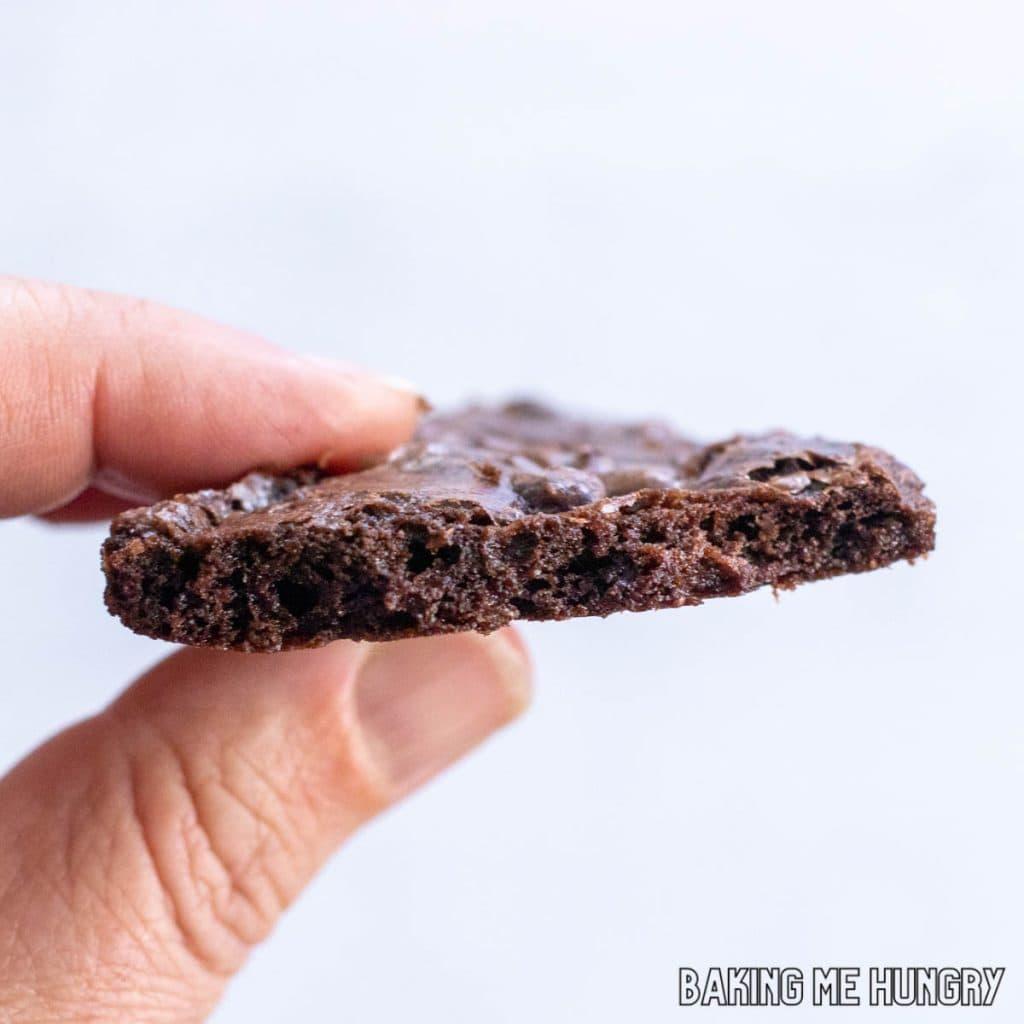 A person holding a plate of brownie brittle bites