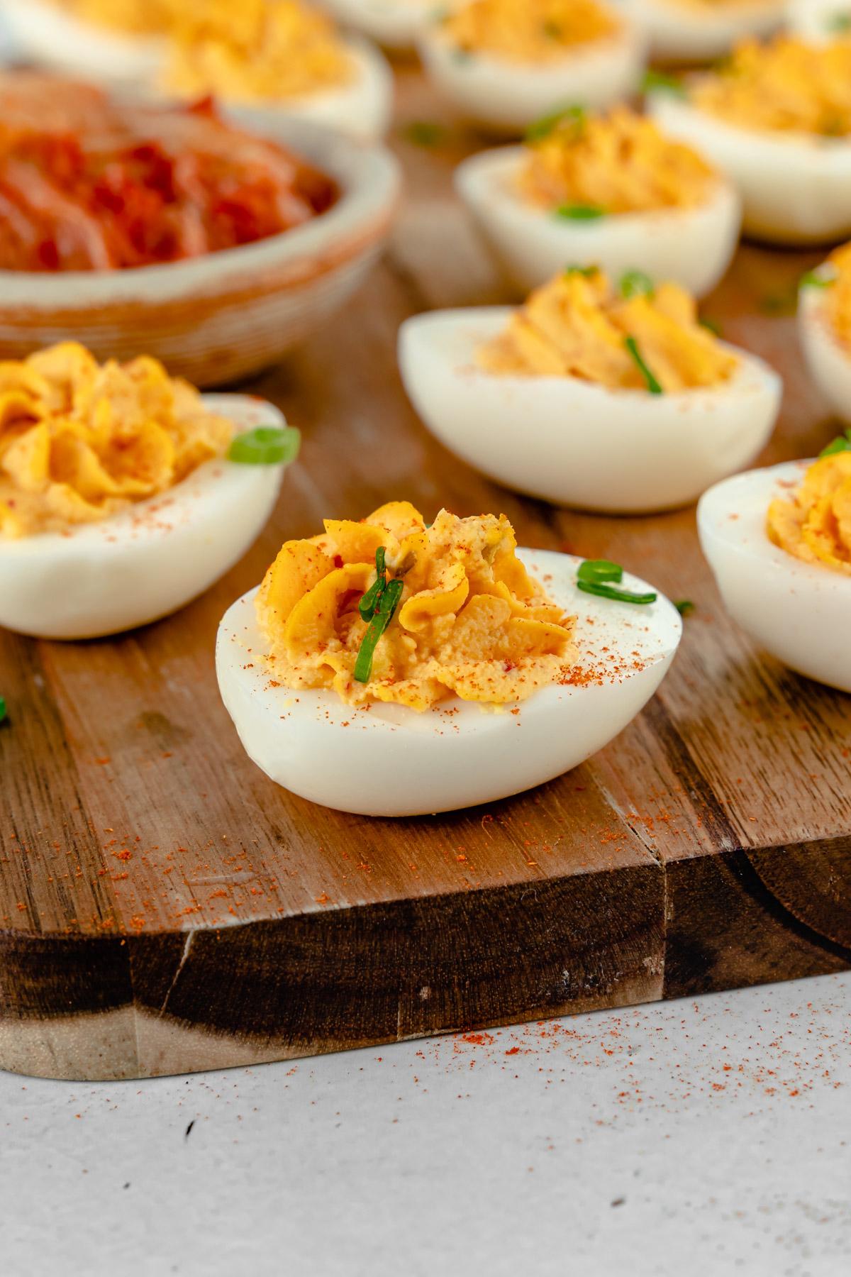 Close-up of a single Kimchi Deviled Egg, showing its creamy texture and vibrant color