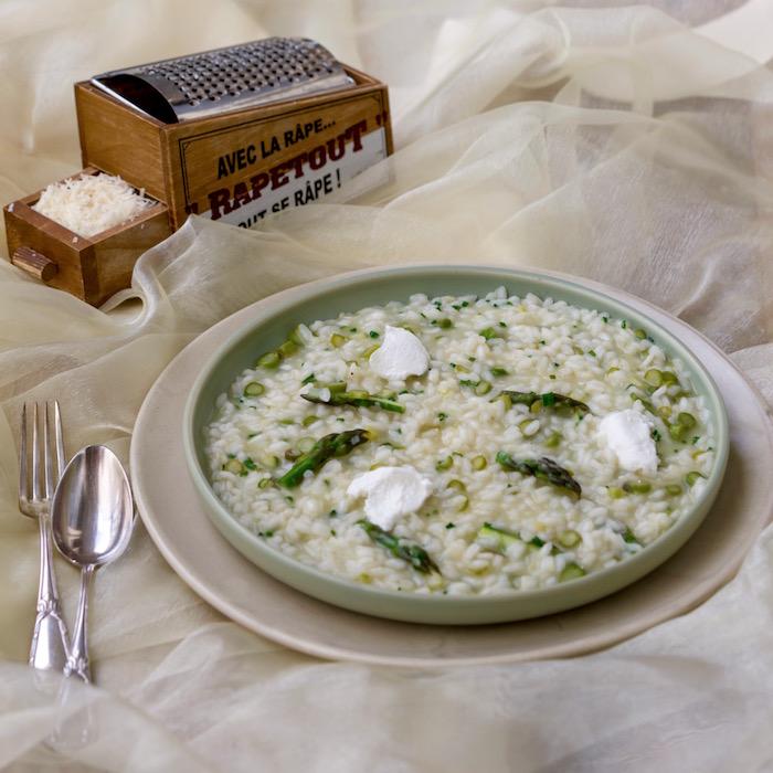close-up of asparagus and goat cheese risotto being served in a bowl