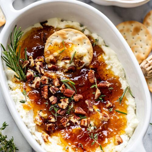 bowl of slow cooker creamy goat cheese and fig chili garnished with cilantro and a dollop of goat cheese