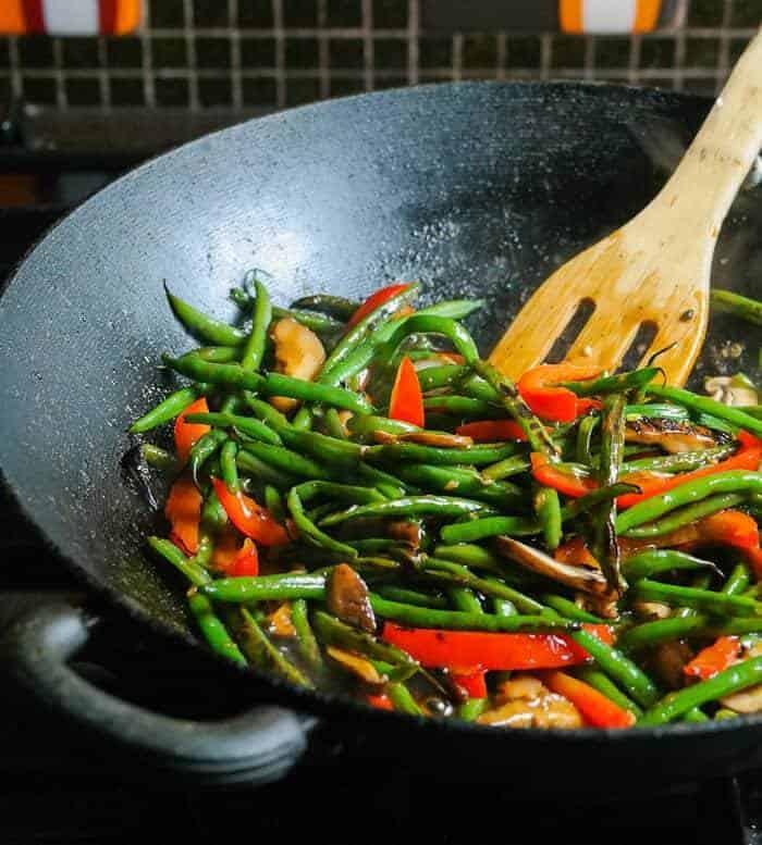 Miso-glazed shiitake and green bean stir-fry in a wok
