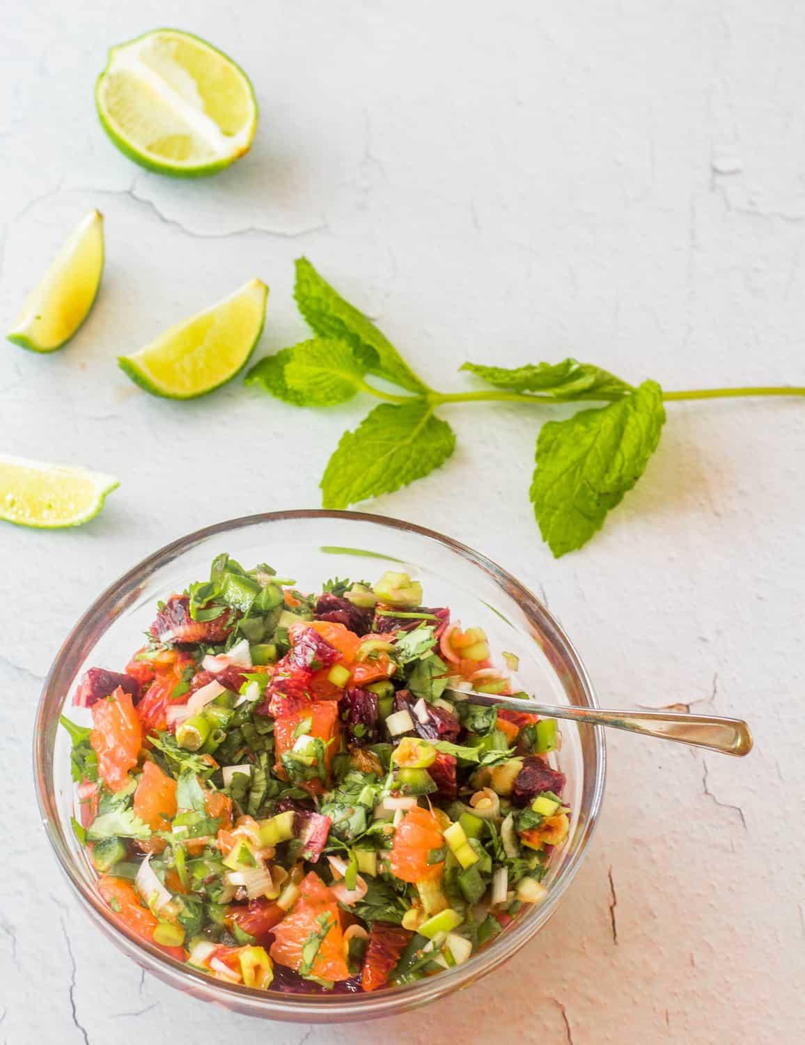 A bright, sunny photo of the finished citrus salsa in a bowl, garnished with cilantro