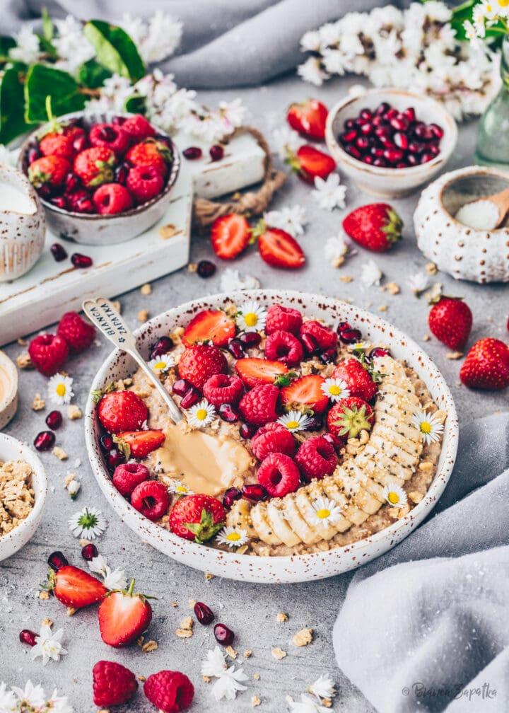 Close up shot of a bowl of oatmeal with hemp milk and chocolate, garnished with fresh berries