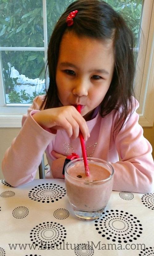 Person drinking a berry chocolate chip smoothie