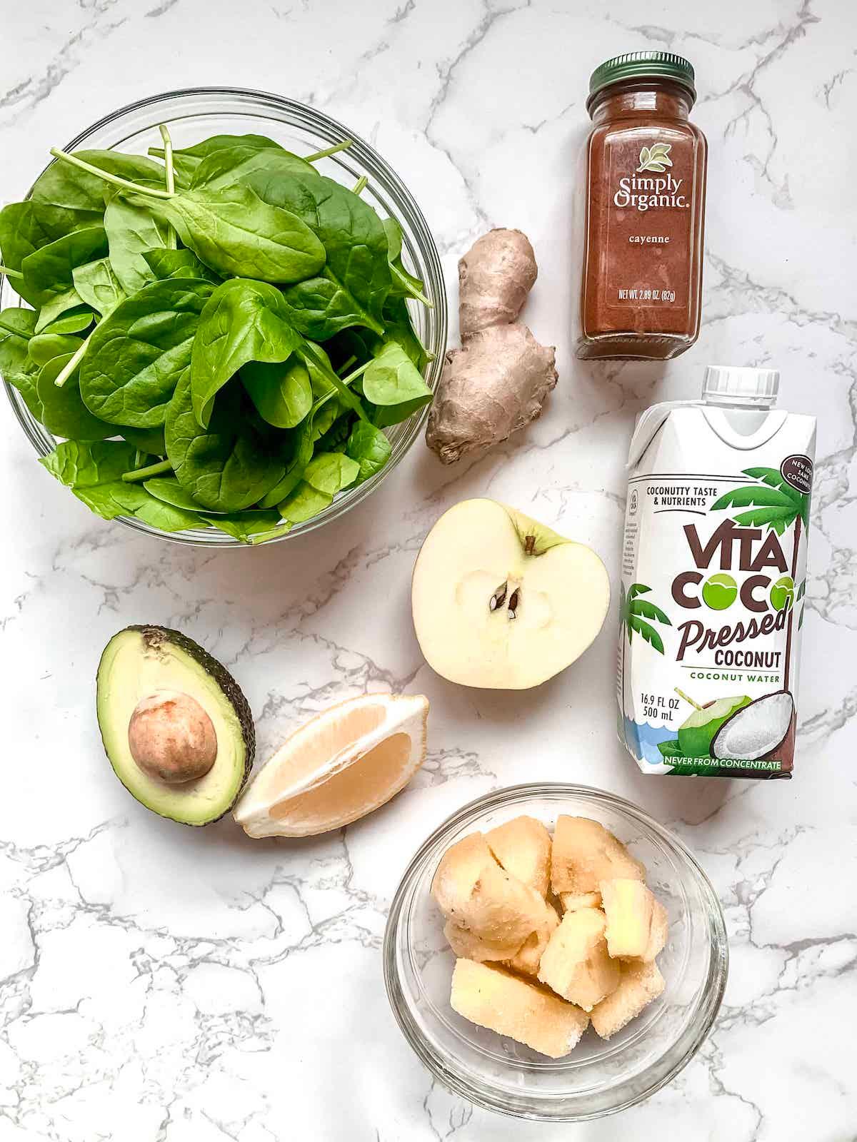 ingredients for a green smoothie laid out on a kitchen counter