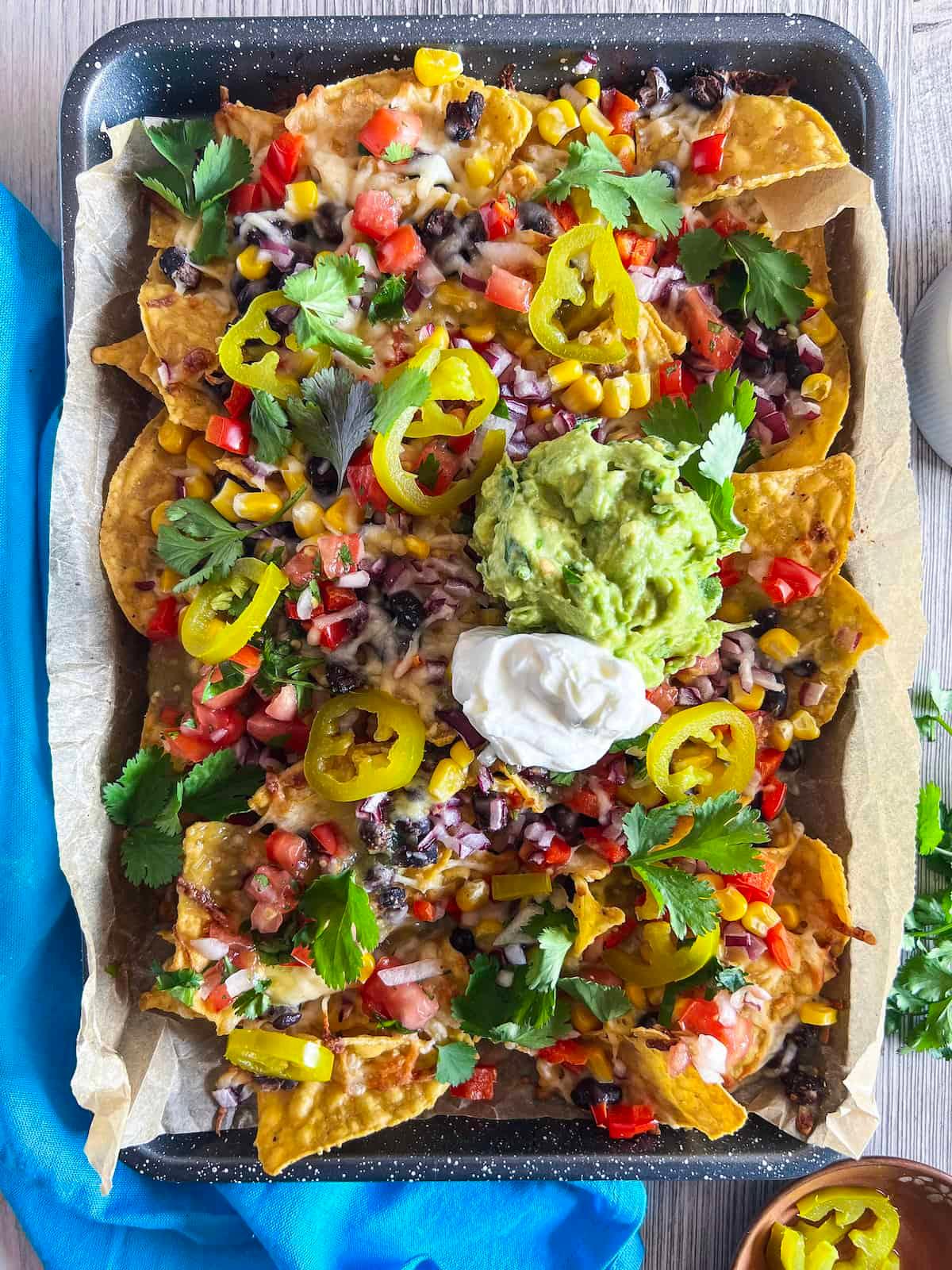 overhead view of fried green bean nachos with various toppings