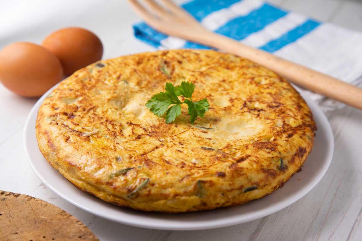A vibrant image showcasing the Tortilla Española Tacos, highlighting the texture and color of the potatoes and eggs
