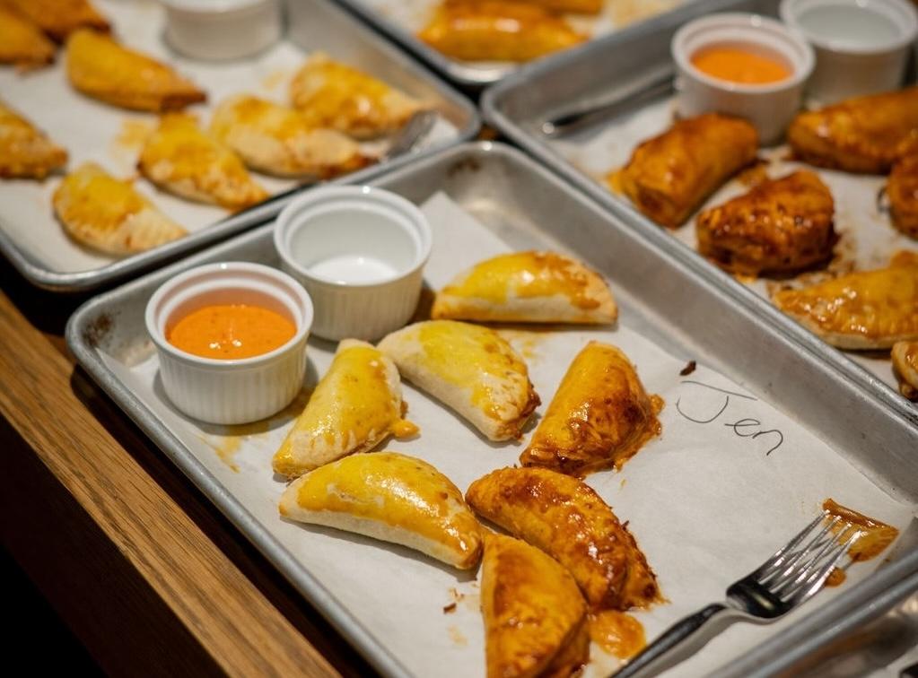 a tray of assorted empanadas with different fillings