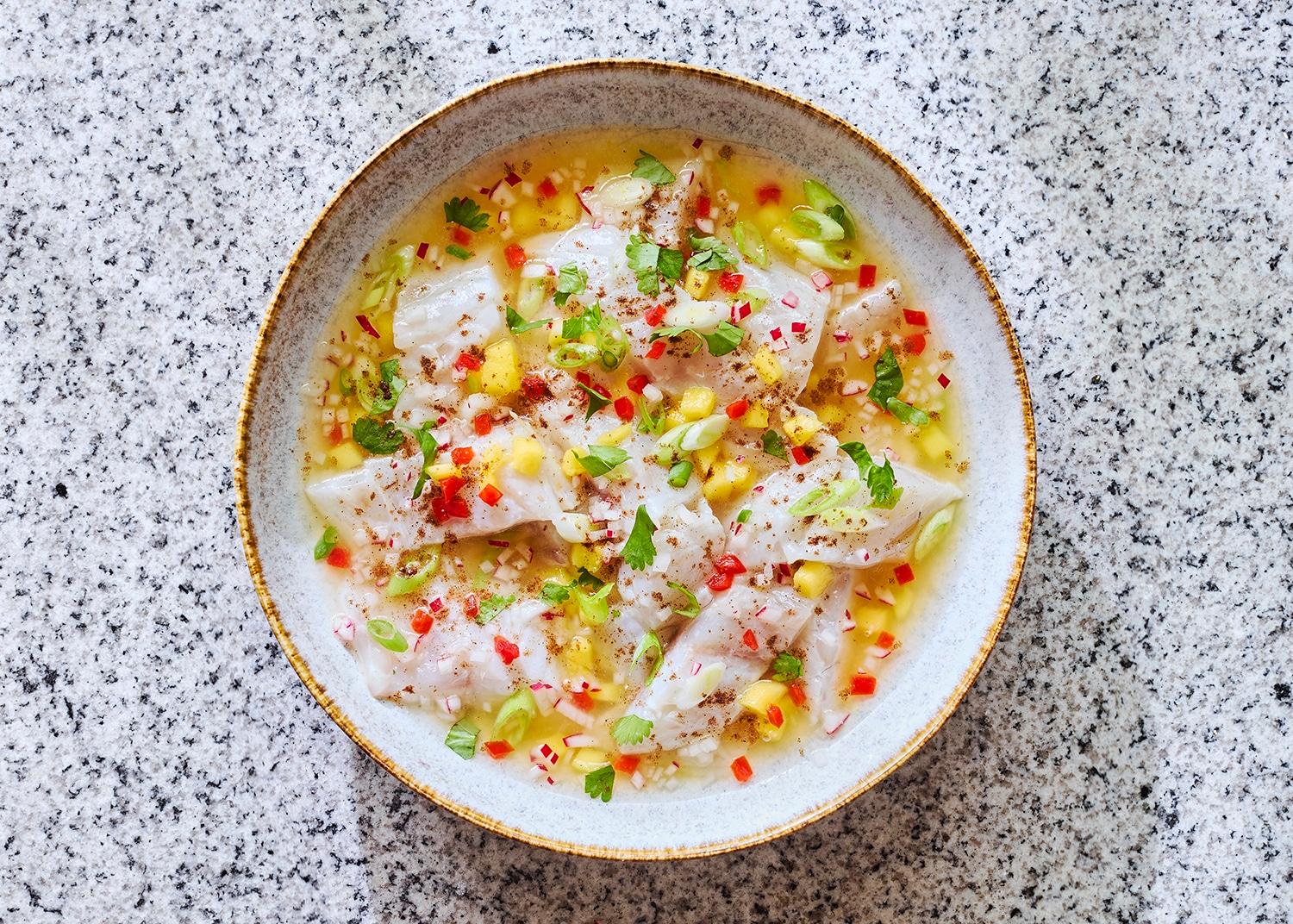 Close-up of thinly sliced radishes being prepared for ceviche
