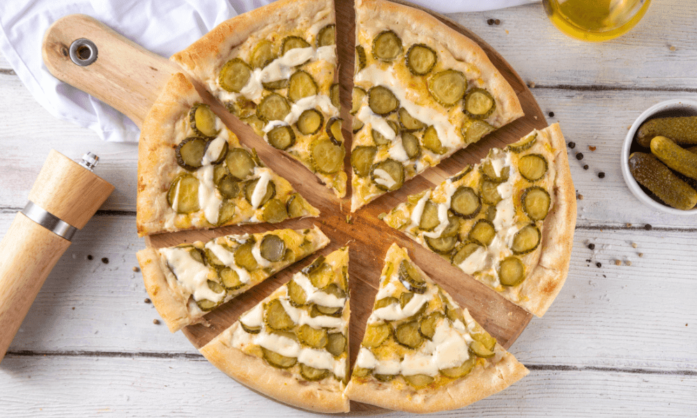 homemade pickle and pizza on wooden board