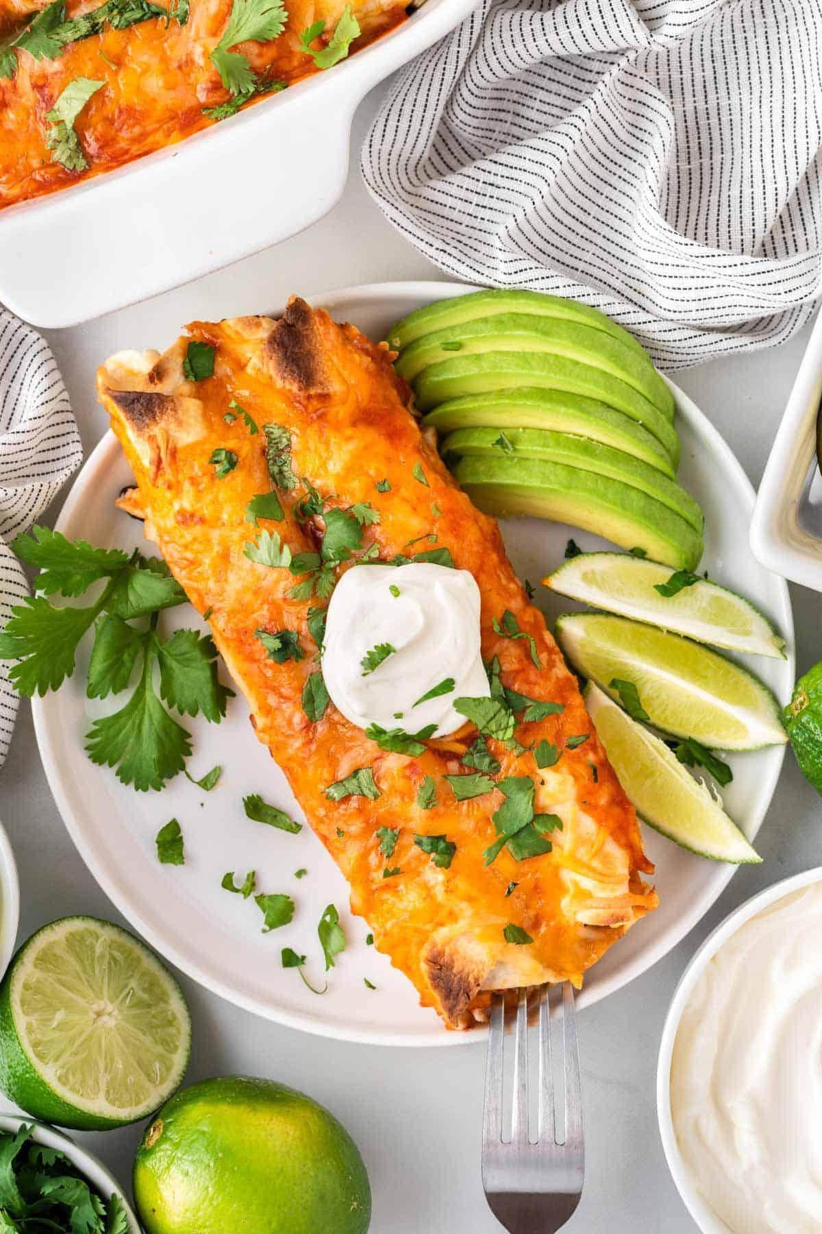 A plate of vegetarian enchiladas garnished with cilantro