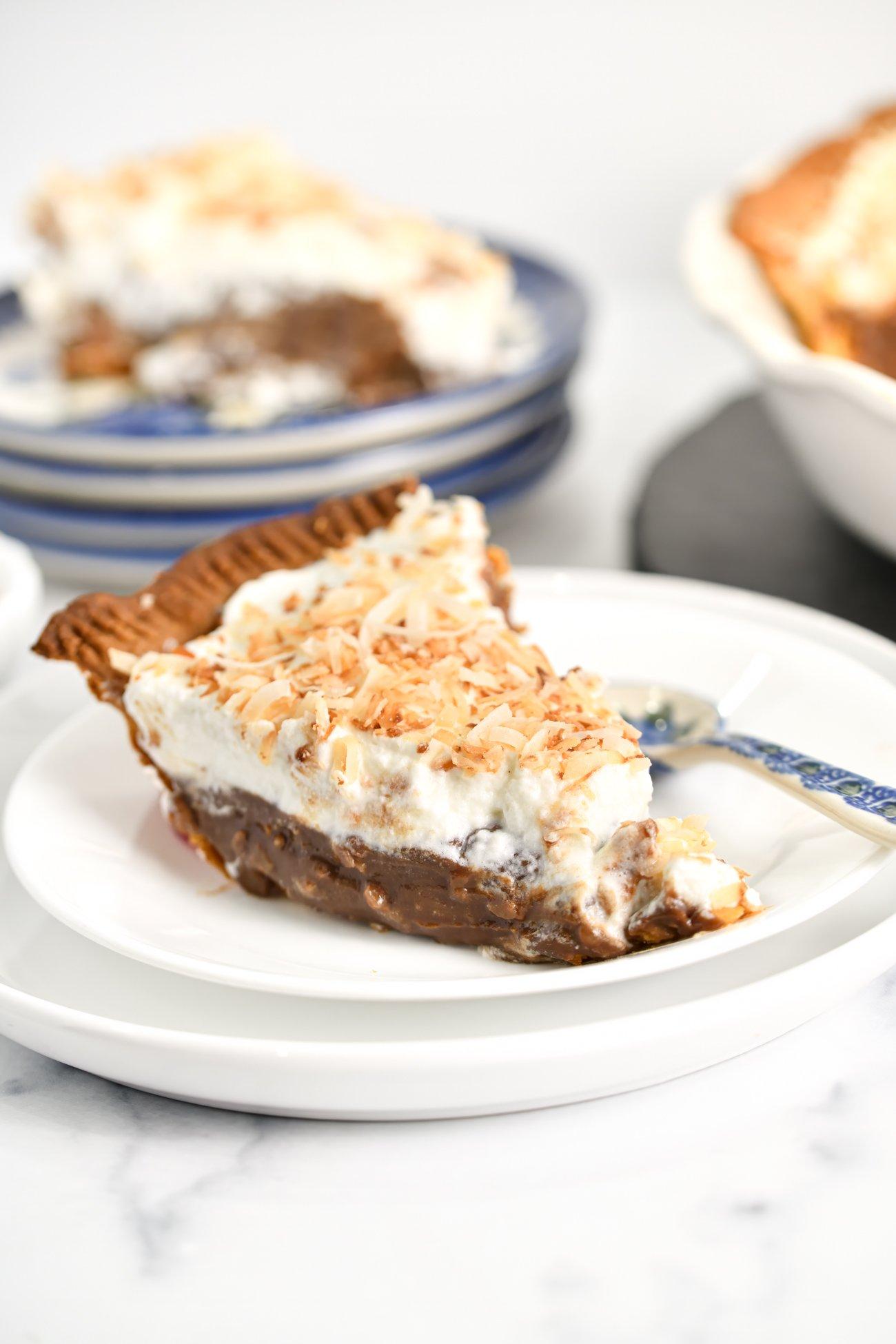 Coconut cream pie with chocolate fondue pouring over a slice
