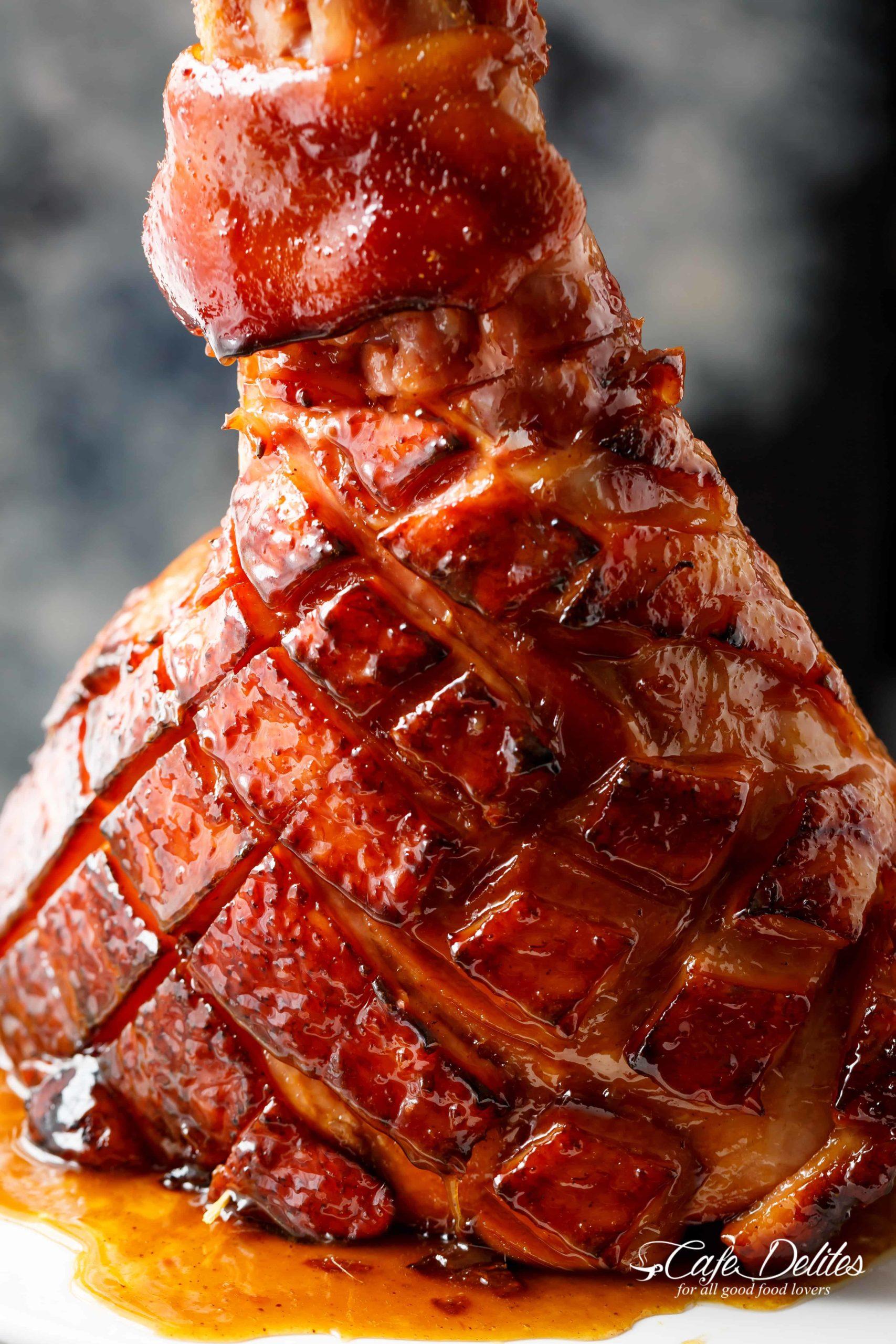 The ham being basted with the glaze in the oven