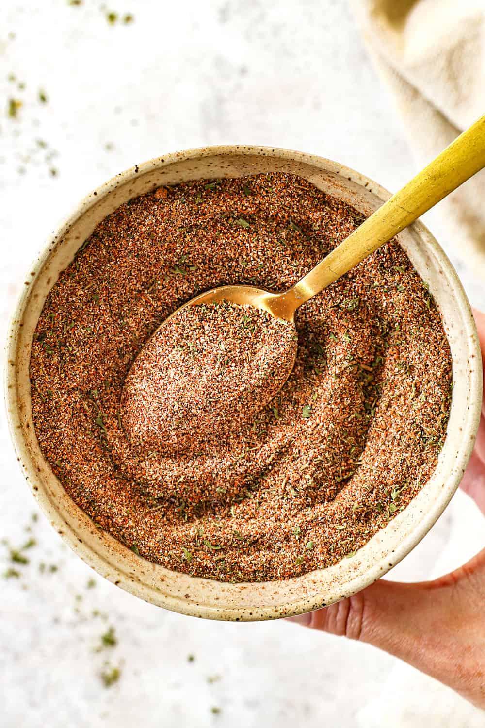 Close-up of a bowl of jerk seasoning with fresh spices