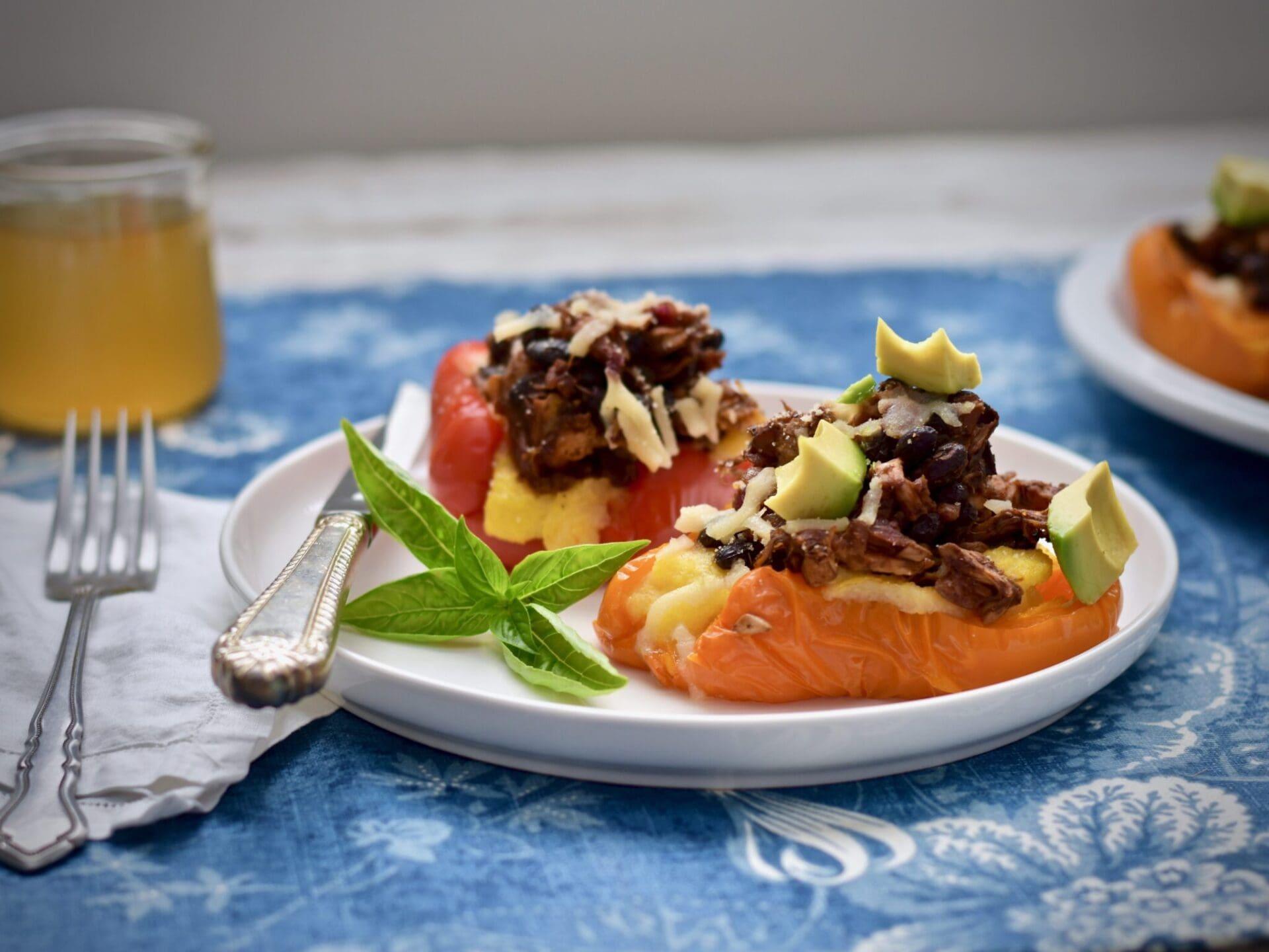 Close-up shot of vibrant BBQ jackfruit stuffed peppers, glistening with sauce, ready to be served