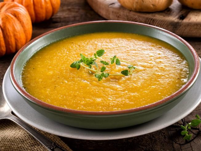 Close-up shot of creamy pumpkin and sausage stew in a slow cooker