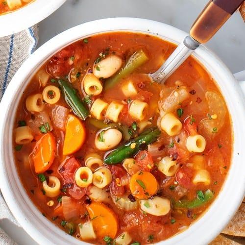 close up of vibrant minestrone soup with fresh vegetables